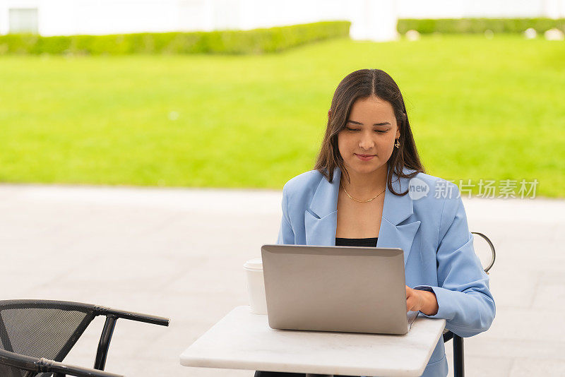 Beautiful european businesswoman working on a laptop in a café